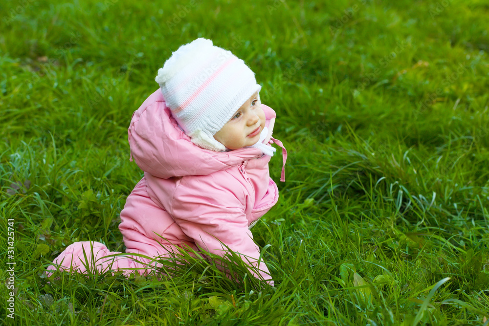 Little girl in pink overalls learns to walk Little girl in pink overalls learns to walk