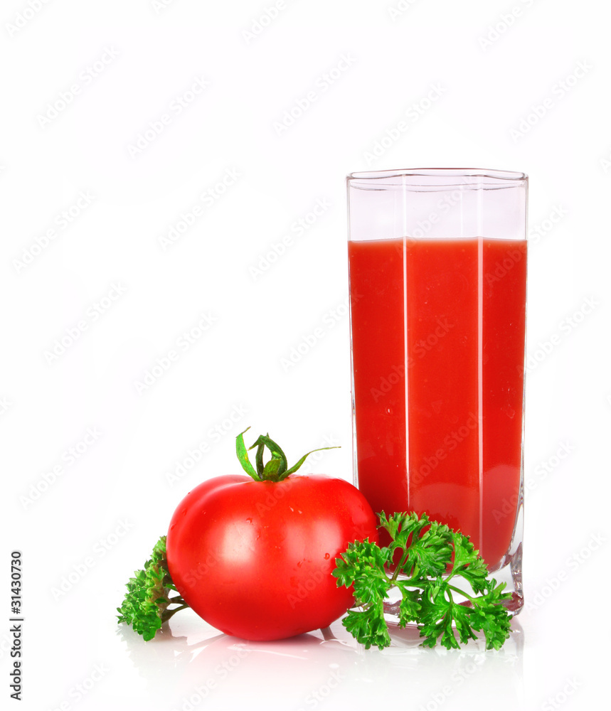 Glass of fresh tomato juice and tomatoes round the glass on th Glass of fresh tomato juice and tomatoes round the glass on th