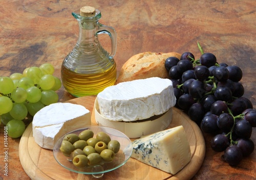 Assortment of cheese on wooden board