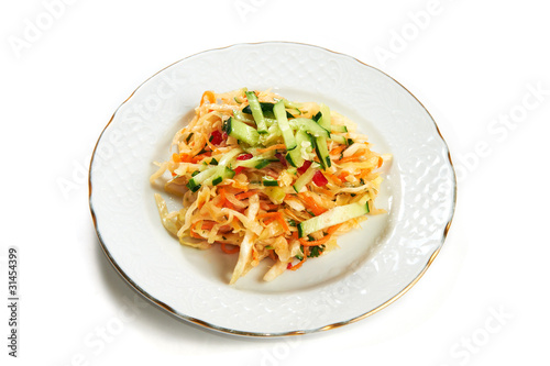 Vitamin salad of cabbage carrots cucumber and pepper isolated