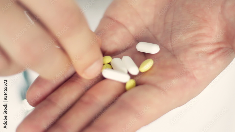 Taking pills from the hand, closeup Taking pills from the hand, closeup