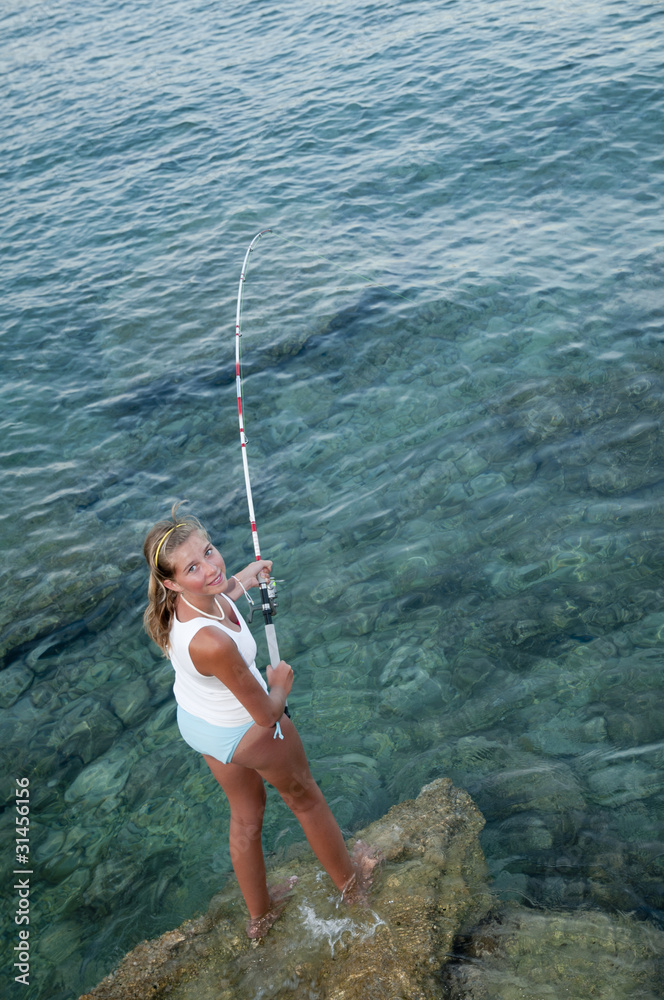Fishing - young girl fishing at the beach Fishing - young girl fishing at the beach