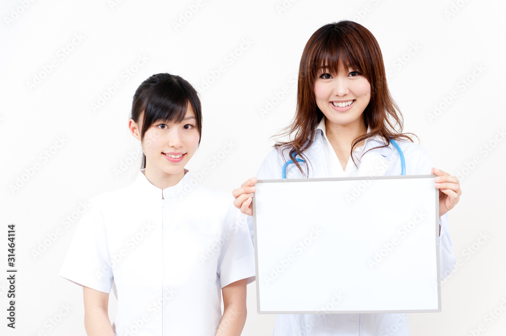 two asian beautiful doctor with blank whiteboard two asian beautiful doctor with blank whiteboard
