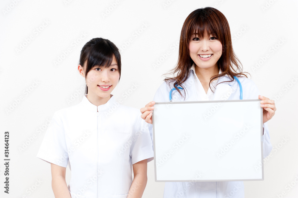 two asian beautiful doctor with blank whiteboard two asian beautiful doctor with blank whiteboard