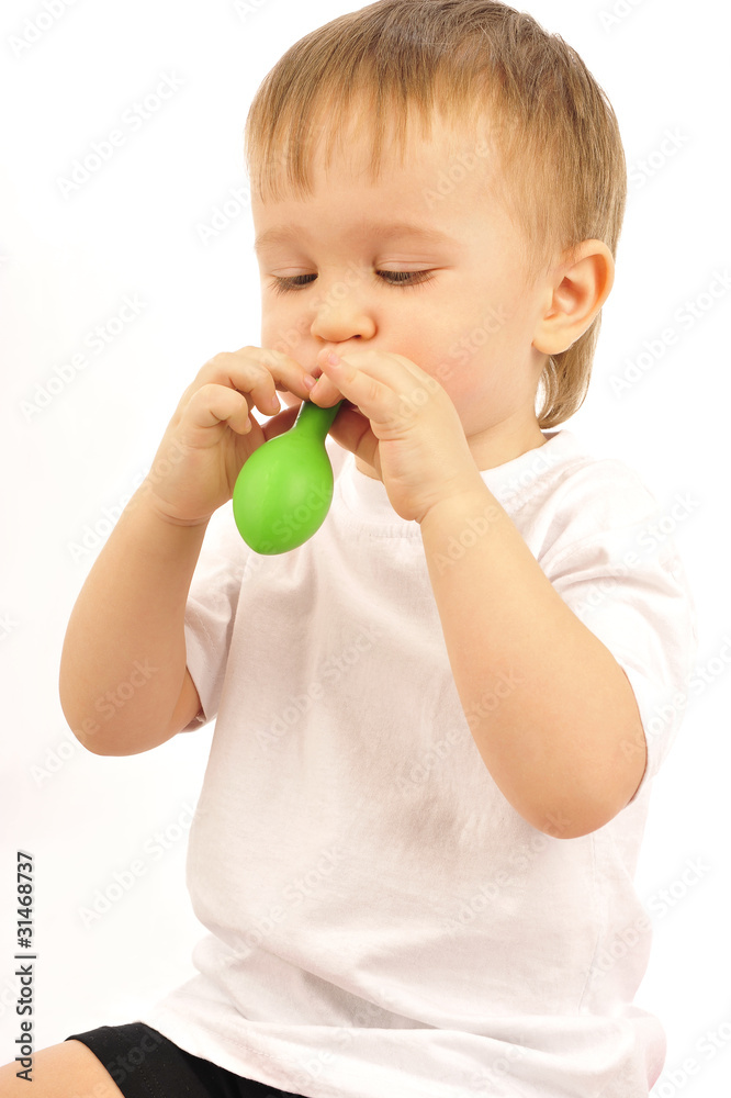 Photo of a little boy blowing up a balloon Photo of a little boy blowing up a balloon