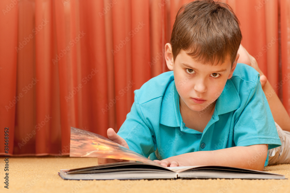 Serious handsome boy with a book