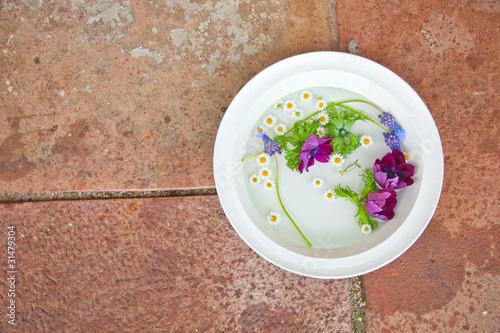 Flowerpod on a stonefloor photo