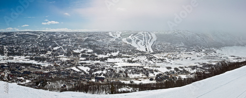 Panoramic view of small city in the valley with winter mountain photo