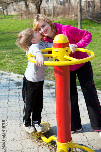 Tablou pe pânză Happy mother with son in playground