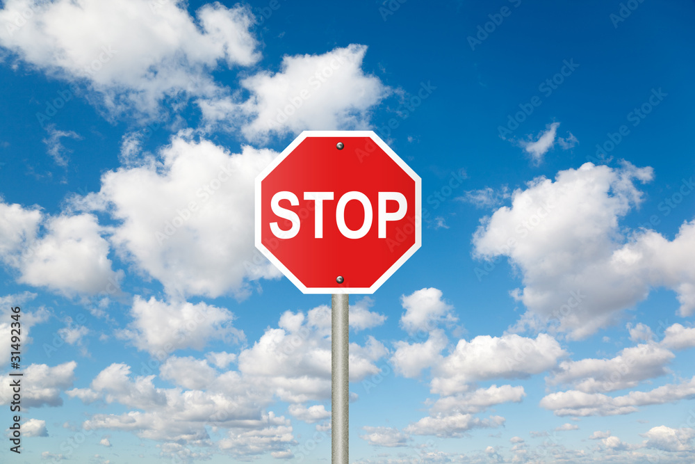 STOP sign on White, fluffy clouds in blue sky collage STOP sign on White, fluffy clouds in blue sky collage