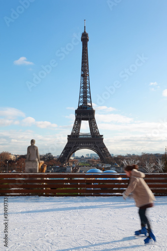 woman are skating, Eiffel Tower in winter at Paris, France © Pavel Losevsky