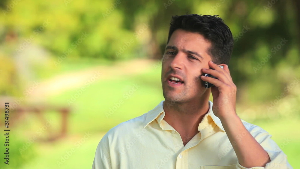 Relaxed man talking on a phone outdoors Relaxed man talking on a phone outdoors