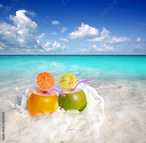 Fototapeta Naklejka Na Ścianę i Meble -  coconut cocktails juice in tropical beach water splash
