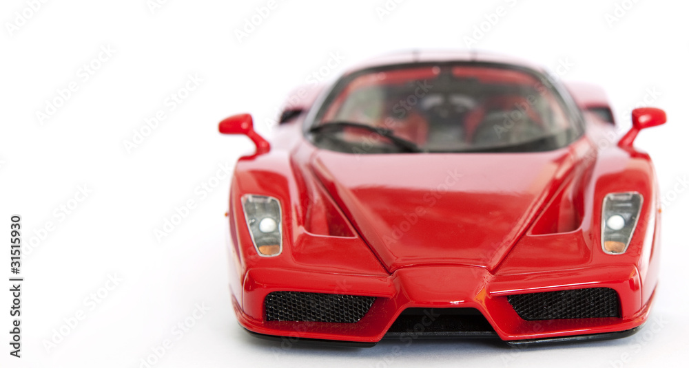 Naklejka premium Red sport car miniature on white background