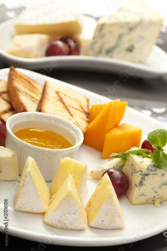 Cheese plate with grapes and honey