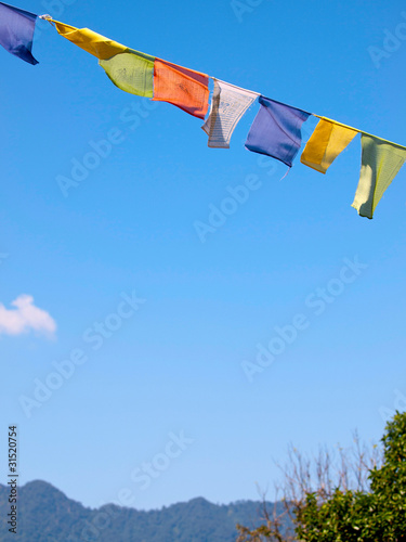Colorful prayer flags over a clear blue sky