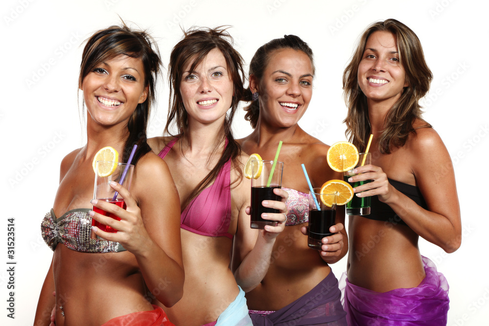 Fototapeta premium Four beautiful girls in bikinis on a white background. All these young women look languidly and sexily into the camera