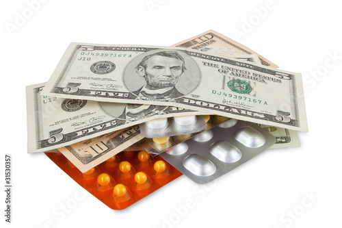 Money and pills isolated on white