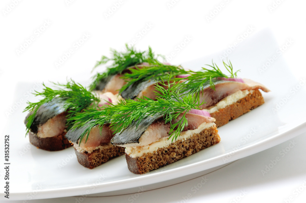 Sandwiches of rye bread with herring, onions and herbs. Sandwiches of rye bread with herring, onions and herbs.