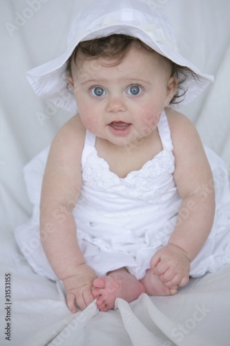 Baby Girl In White Dress And Hat