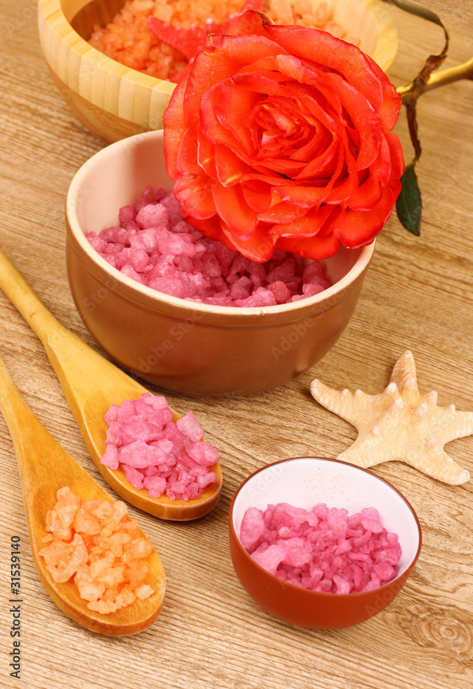 Bath aromatic salt, rose and sea stars on wooden background Bath aromatic salt, rose and sea stars on wooden background