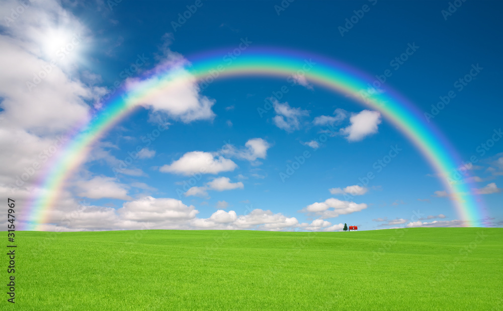 Green grass and red roof house and rainbow Green grass and red roof house and rainbow