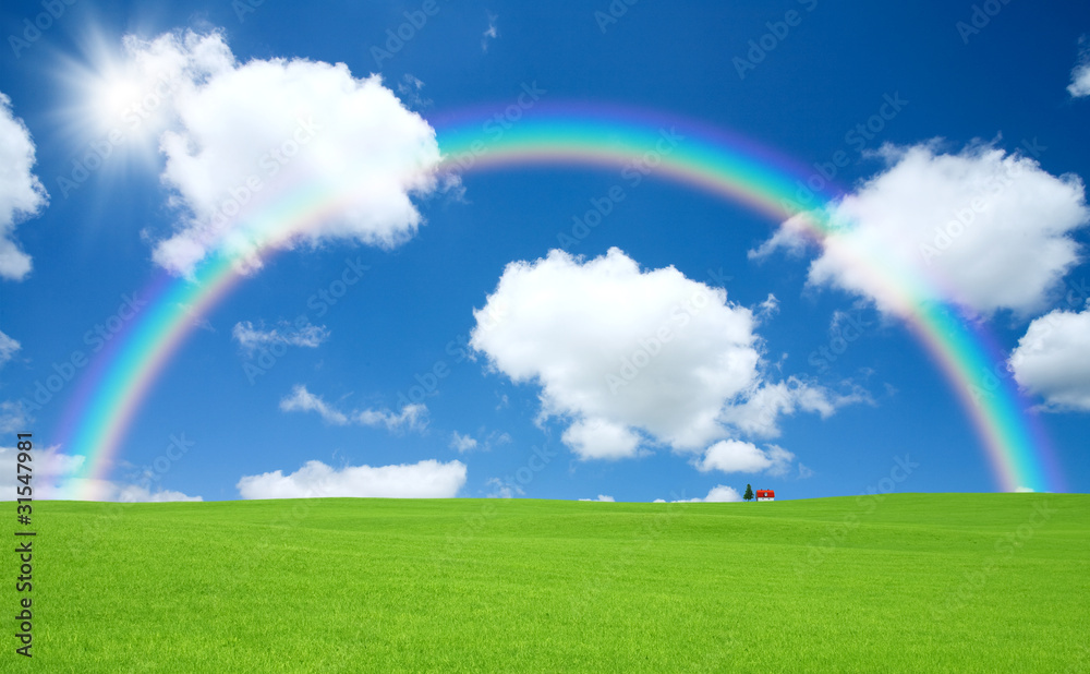 Green grass and red roof house and rainbow Green grass and red roof house and rainbow
