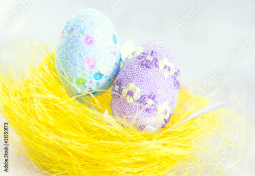 Hand painted beautiful colorful easter eggs in wicker basket