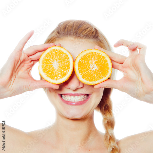Young woman with oranges in her hands