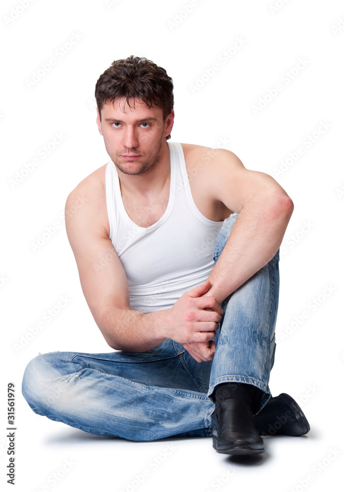 man in jeans sitting on an isolated background