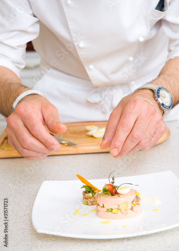 Chef decorate plate with food