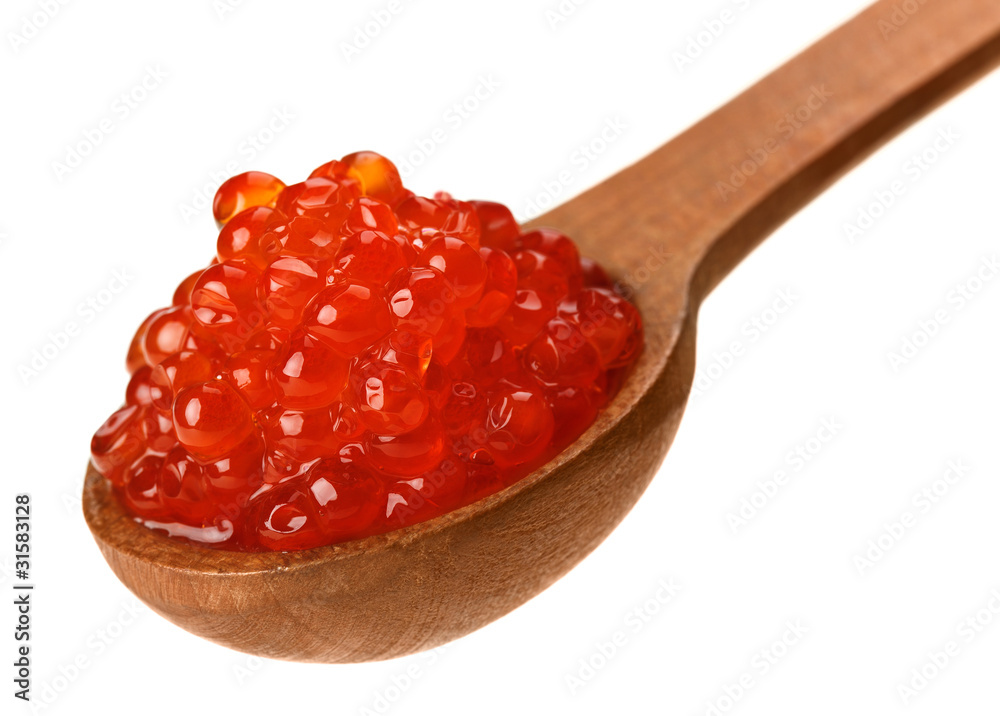 Red salmon caviar heap in wooden spoon Red salmon caviar heap in wooden spoon