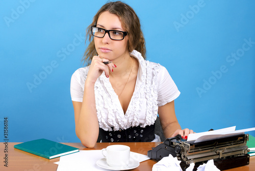 Cute female author with vintage typewriter photo