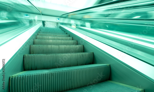 angle view to modern green steps of moving business escalator © Vladitto