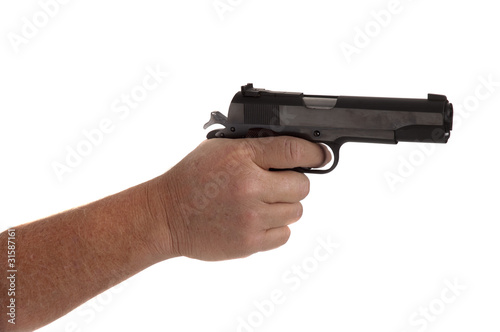 handgun cocked in a hand isolated on white