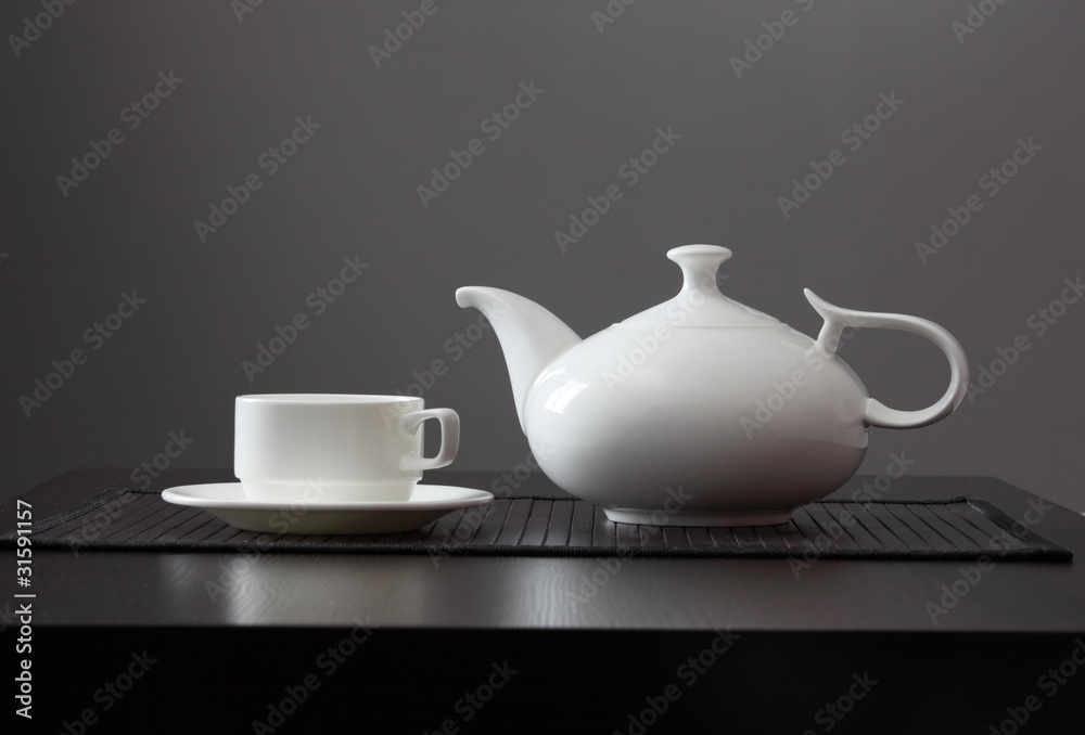 White teapot with a mug White teapot with a mug