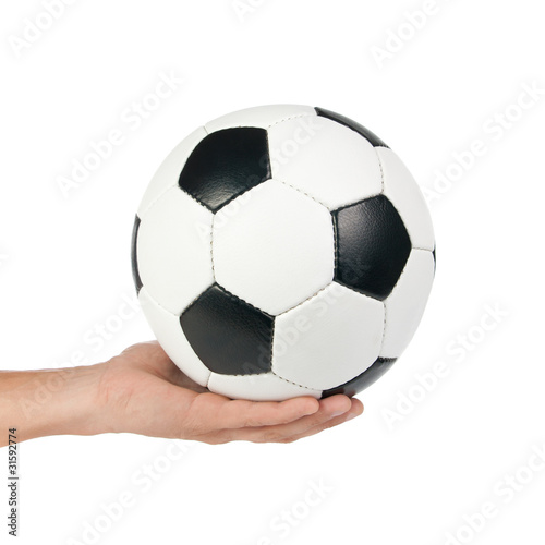 Classic soccer ball at outstretched hand.
