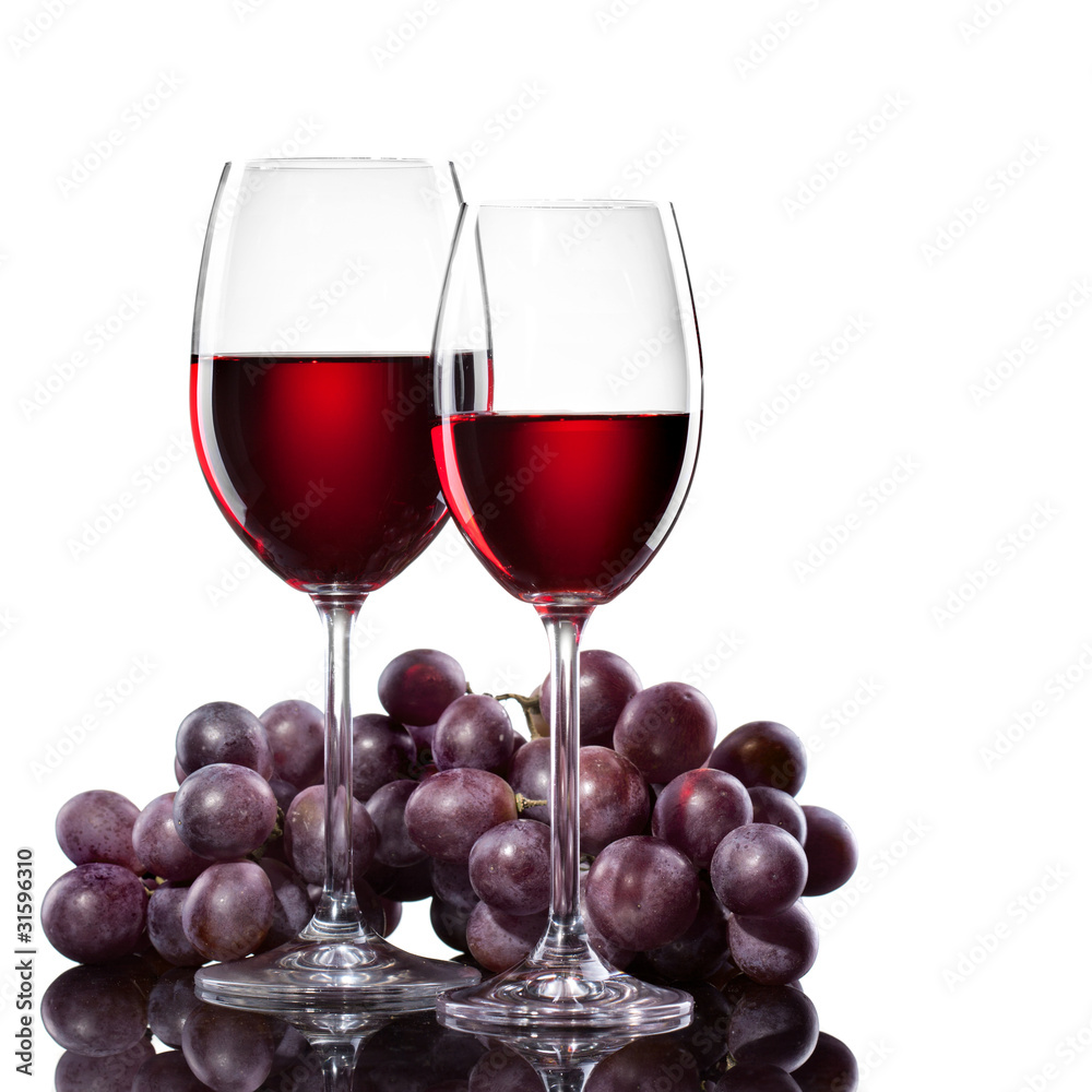 Red wine in glasses with grape isolated on white