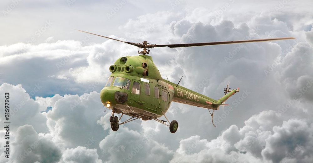 Fototapeta premium Helicopter MI-2 flight, Russia against clouds