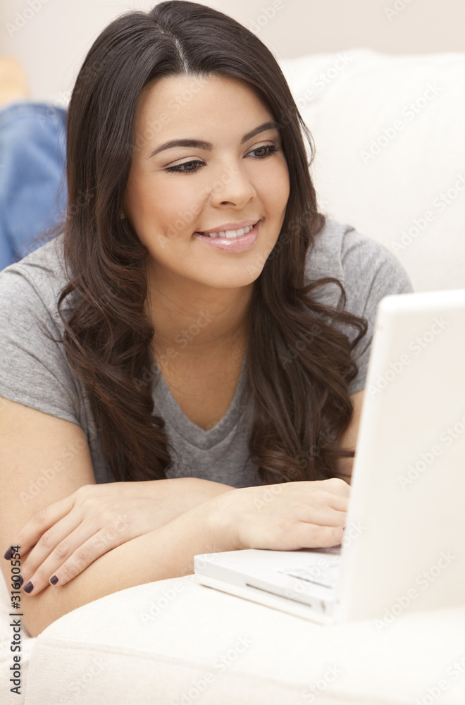Beautiful Hispanic Woman Laying on Sofa Using Laptop Computer Beautiful Hispanic Woman Laying on Sofa Using Laptop Computer