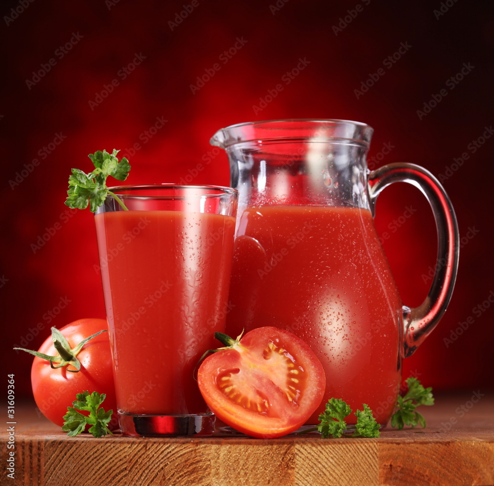 Jug and glass full of tomato juice. Jug and glass full of tomato juice.