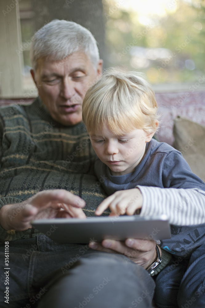 Grandfather and grandson using Tablet PC