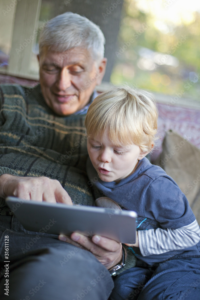 Grandfather and grandson using Tablet PC Grandfather and grandson using Tablet PC