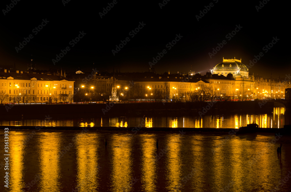 Night lights of Prague National Theater and the Vlava river quay