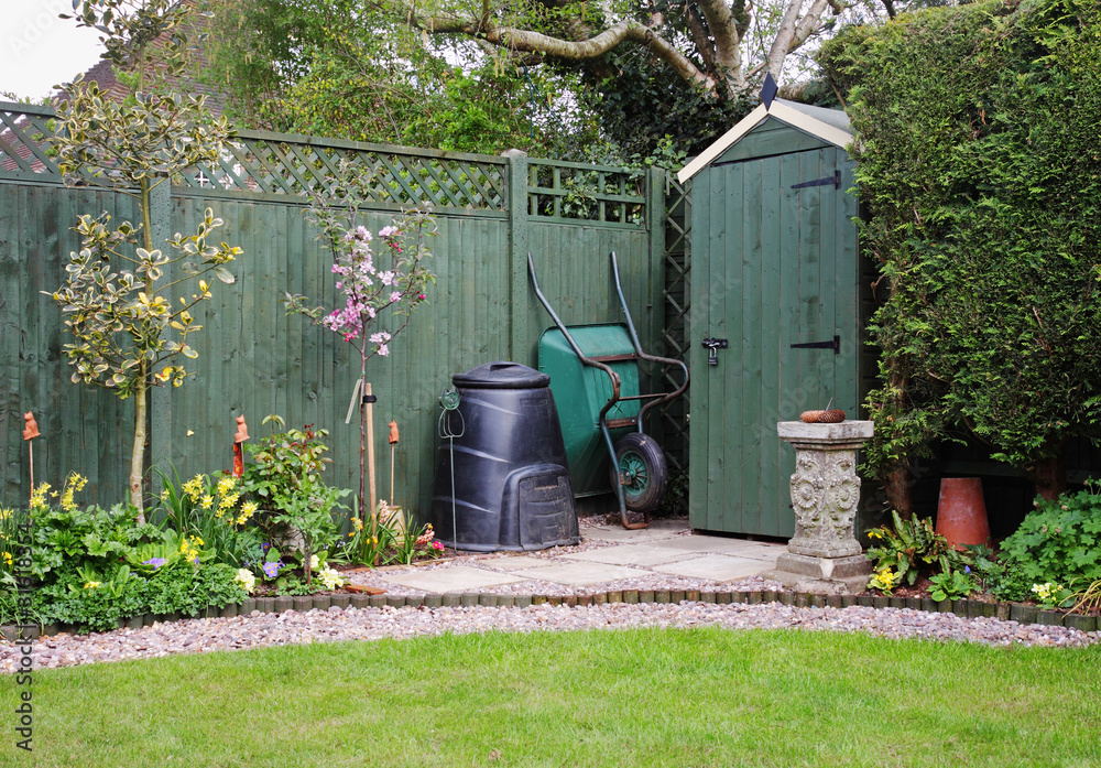 Garden Shed in an English Garden with compost bin