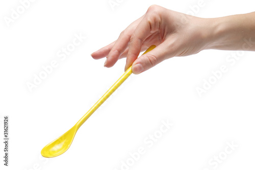 Hand holding an empty teaspoon