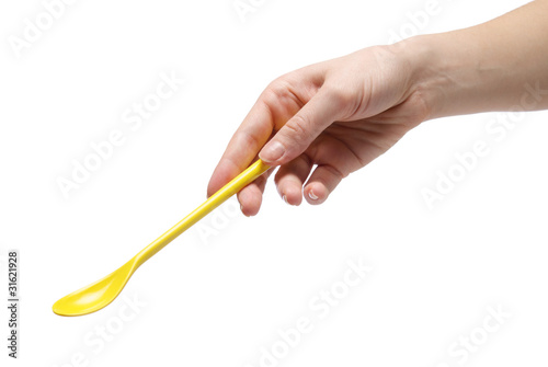 Hand holding an empty teaspoon