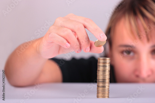 Young woman counting her savings photo