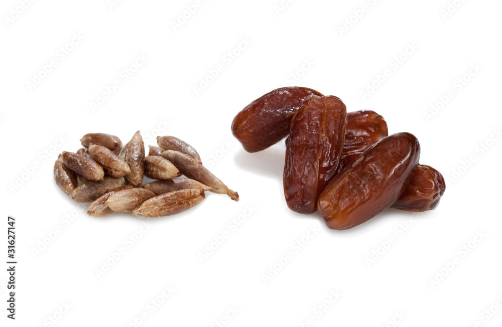 Date-stones and dates. Isolated on white background. Date-stones and dates. Isolated on white background.