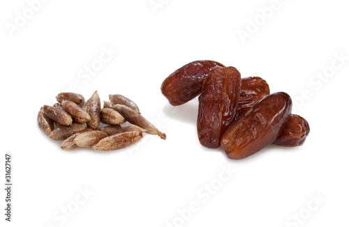 Date-stones and dates. Isolated on white background.